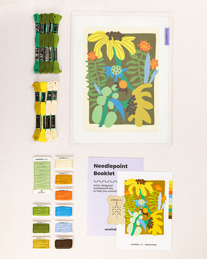 flower market needlepoint kit contents: printed canvas, threads, needles, and instruction booklet, graphic flyer laid flat