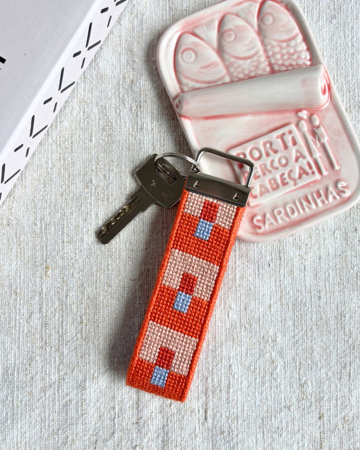 Focus Key Fob placed on top of a pink ceramic can of sardines
