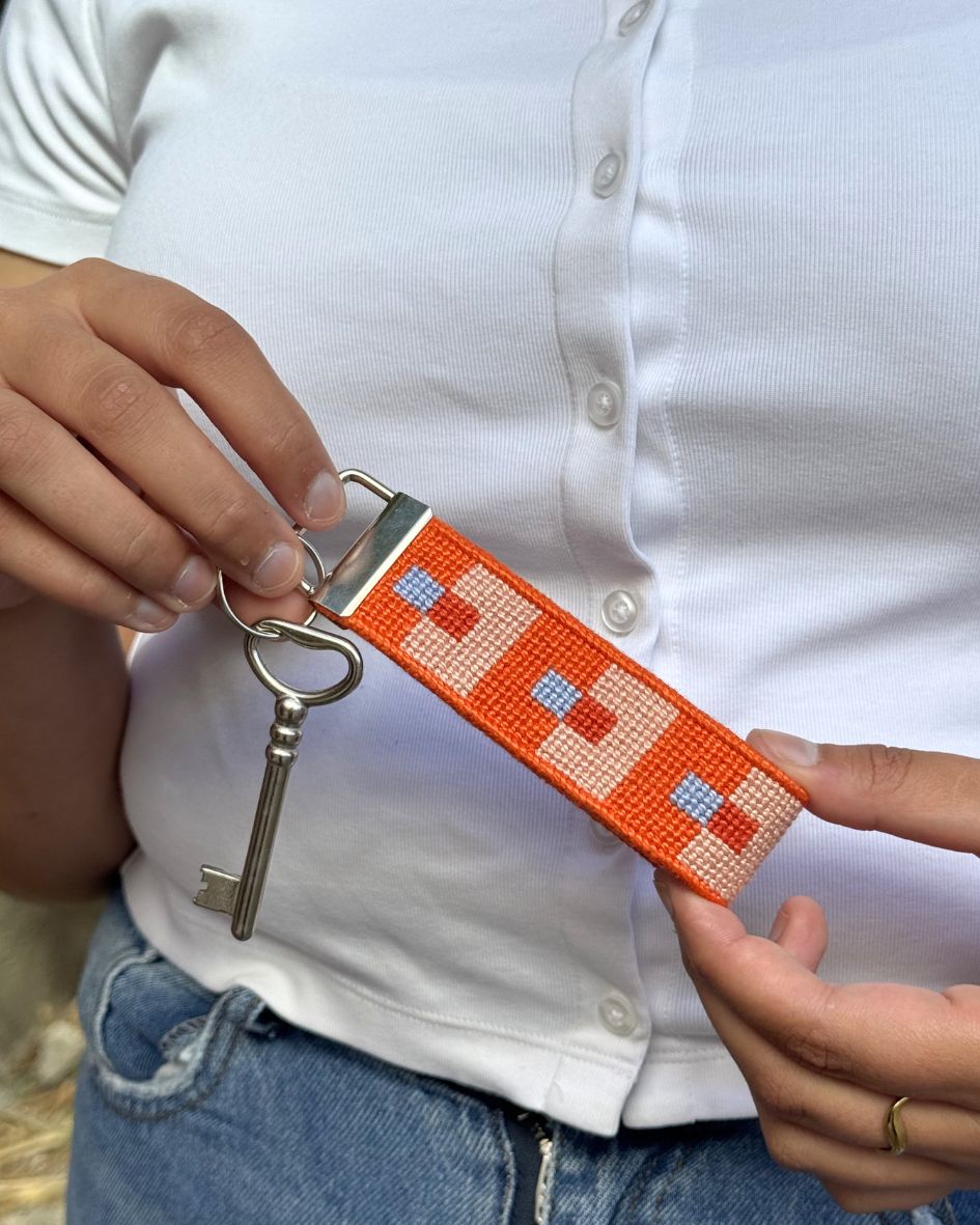 FocusKey Fob with a key being held by a pair of hands on a white shirt background
