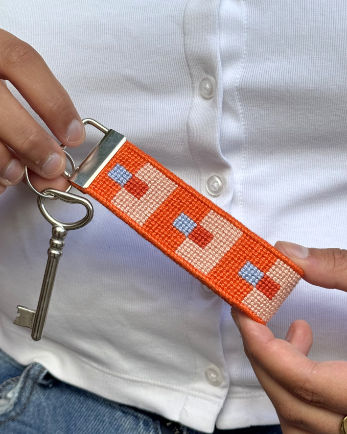 FocusKey Fob with a key being held by a pair of hands on a white shirt background