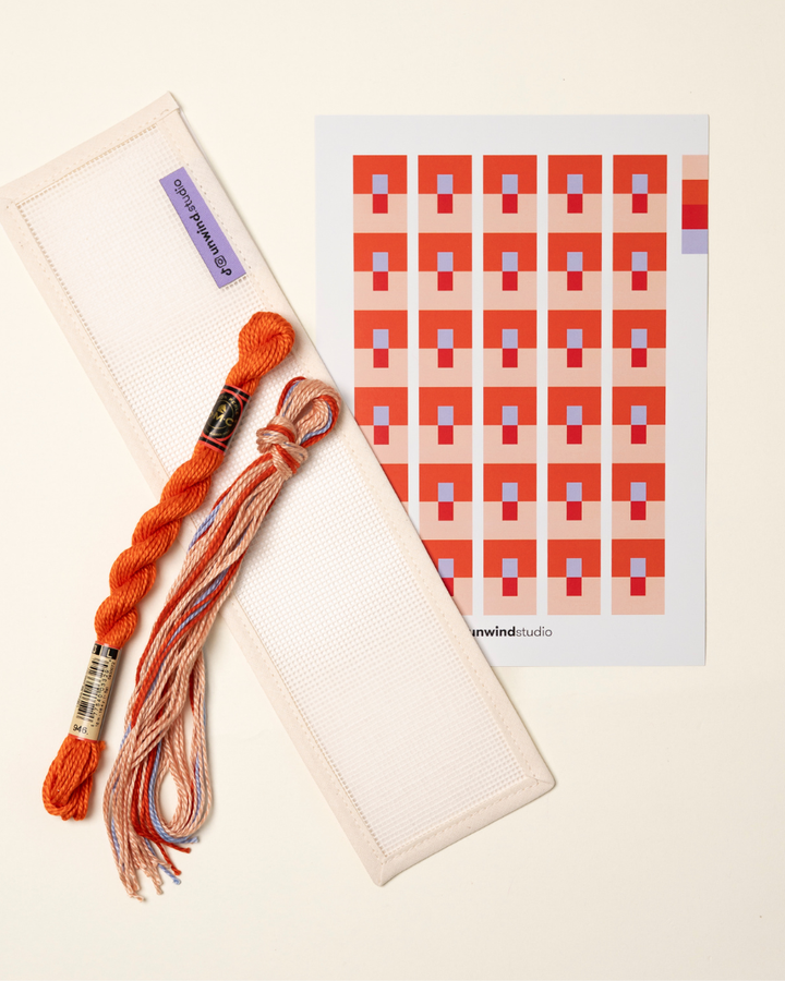 flat view of the Focus Key Fob Needlepoint Kit with blank canvas, matching threads and a graphic flyer