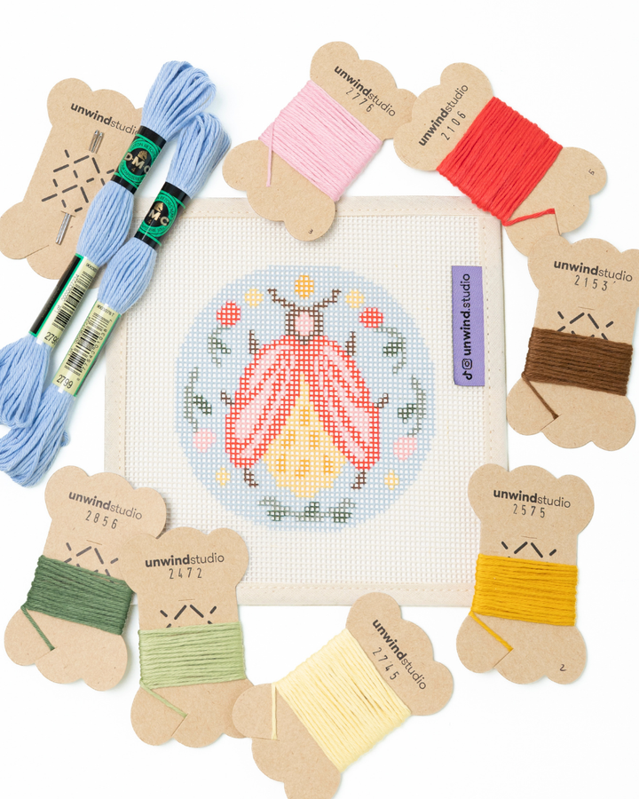 flat view of the folk beetle needlepoint canvas with matching bold colored threads  

