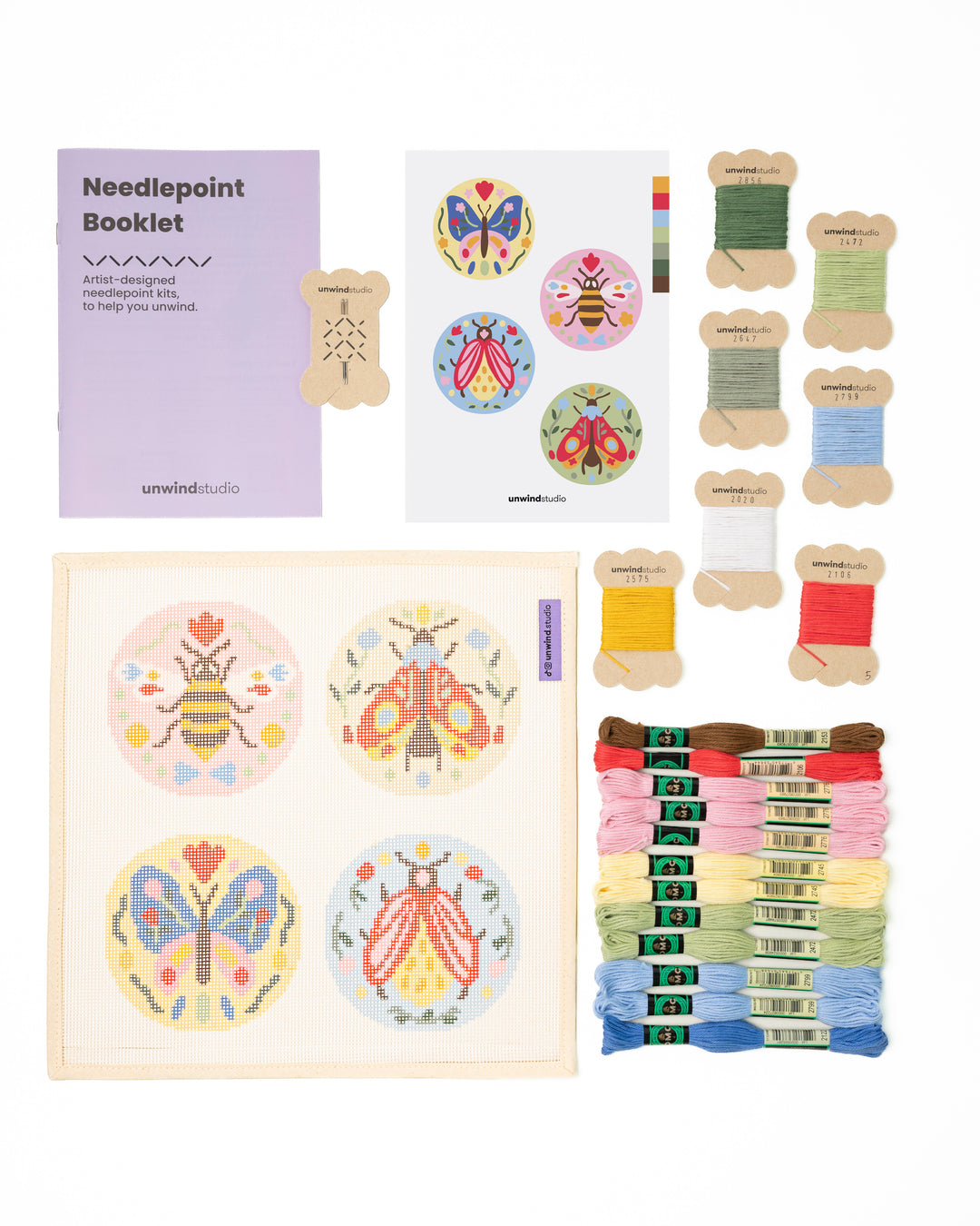 Flat view of the Folk Insect Needlepoint Ornament Set by Unwind Studio with an instructional booklet, needle, dmc soft cotton threads and a graphic flyer