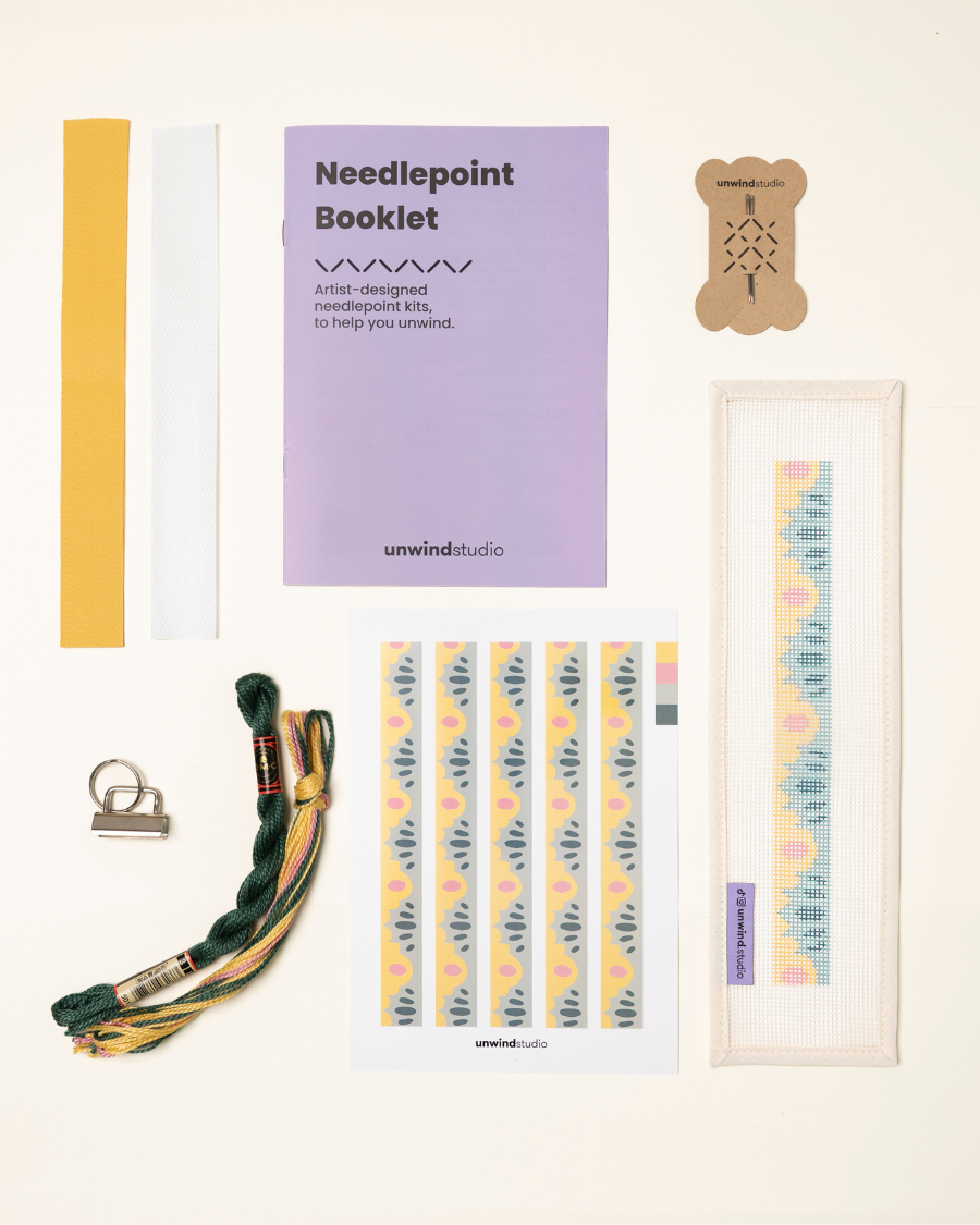 High Seas Complete Needlepoint Kit with finishing materials such as fusible web and cotton twill tape, key fob hardware plus matching threads, set of needles, a graphic flyer and a instructional booklet.