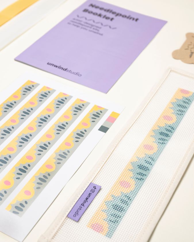 diagonal view of the High Seas Key Fob Needlepoint Kit with printed canvas, matching threads and finishing materials and a instructional booklet
