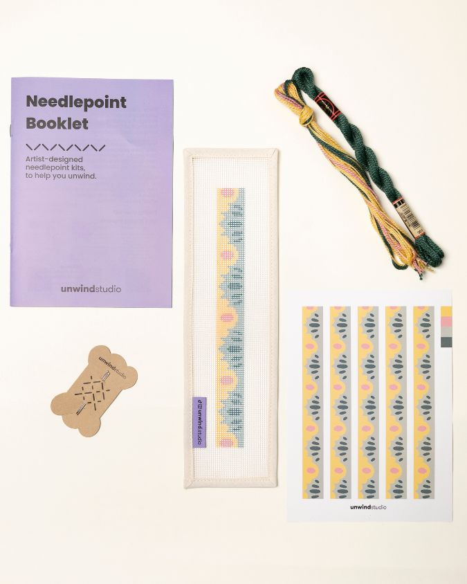 flat view of the High Seas Key Fob Needlepoint Kit with printed canvas, matching threads, a instructional booklet and a graphic flyer
