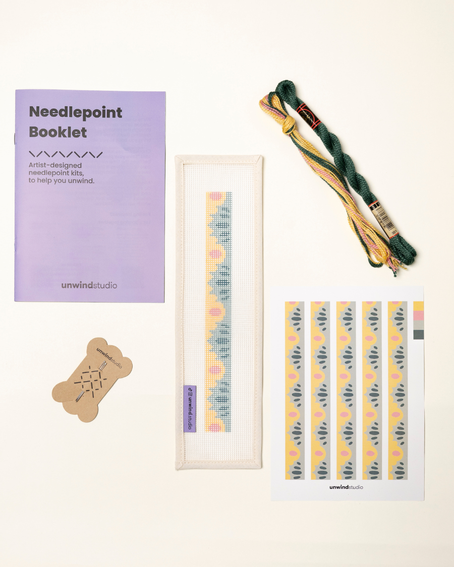 flat view of the High Seas Key Fob Needlepoint Kit with printed canvas, matching threads, a instructional booklet and a graphic flyer