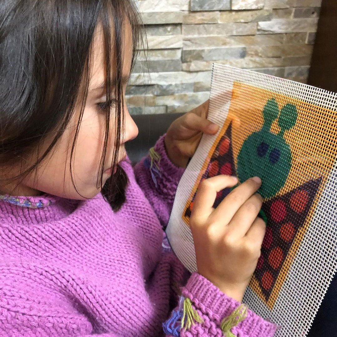 girl doing a butterfly needlepoint design