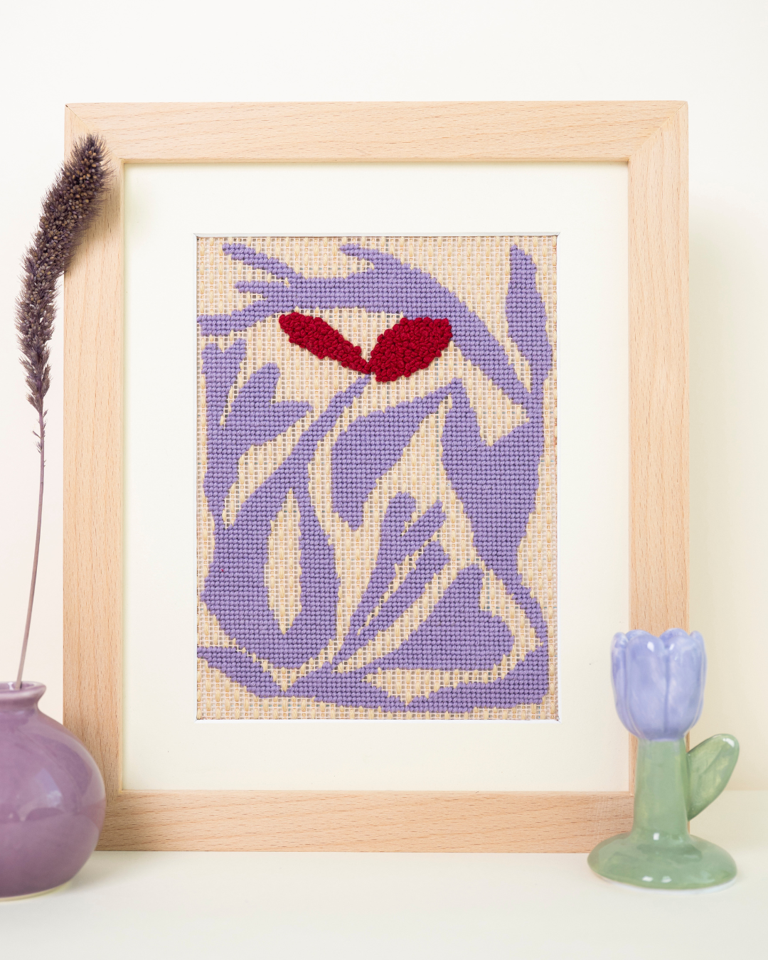 frontal shot of unwind studio morning walk needlepoint kit paired with matching decoration.