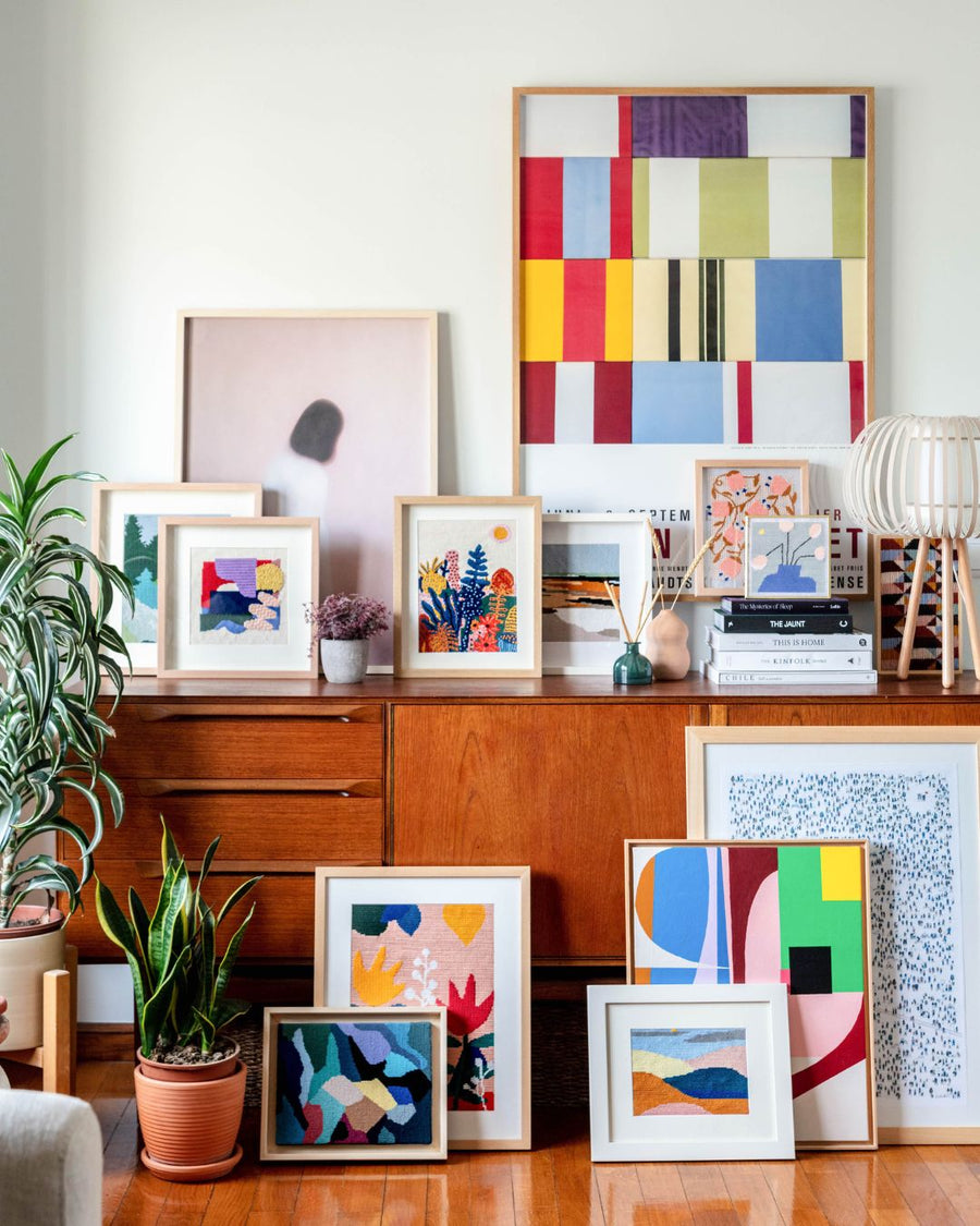 a needlepoint wall art framed and displayed in a christmas scenario as home decor