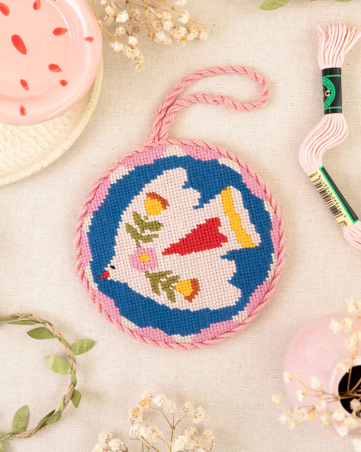 noon folk bird ornament finished and placed next to matching bright soft pink elements