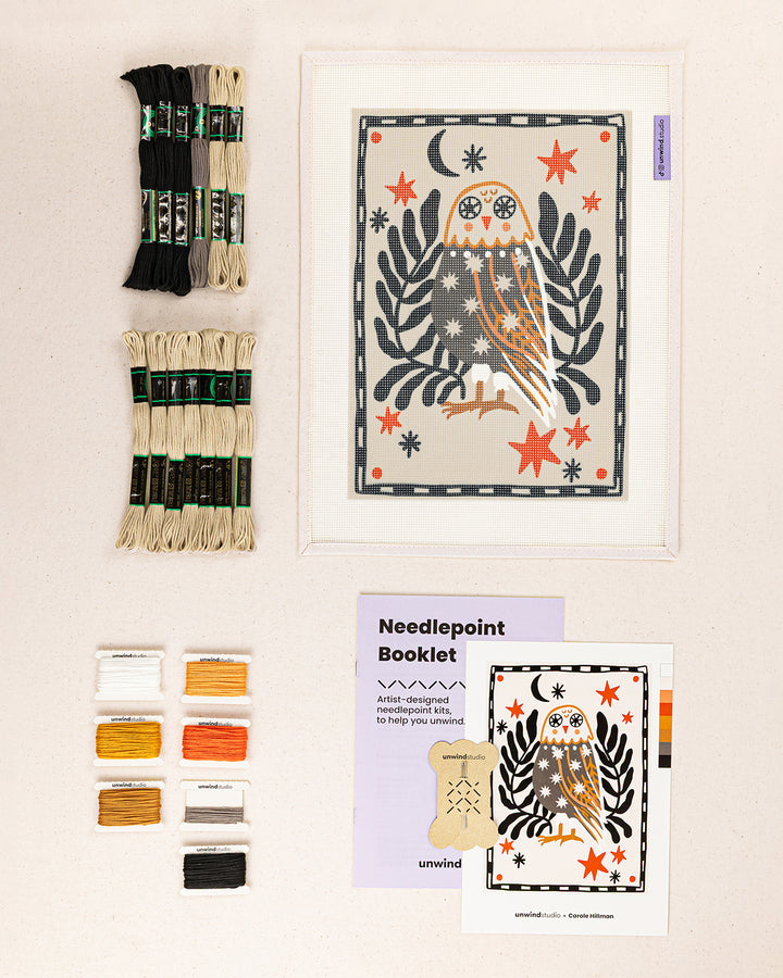 folk owl needlepoint kit contents: printed canvas, threads, needles, and instruction booklet, graphic flyer laid flat