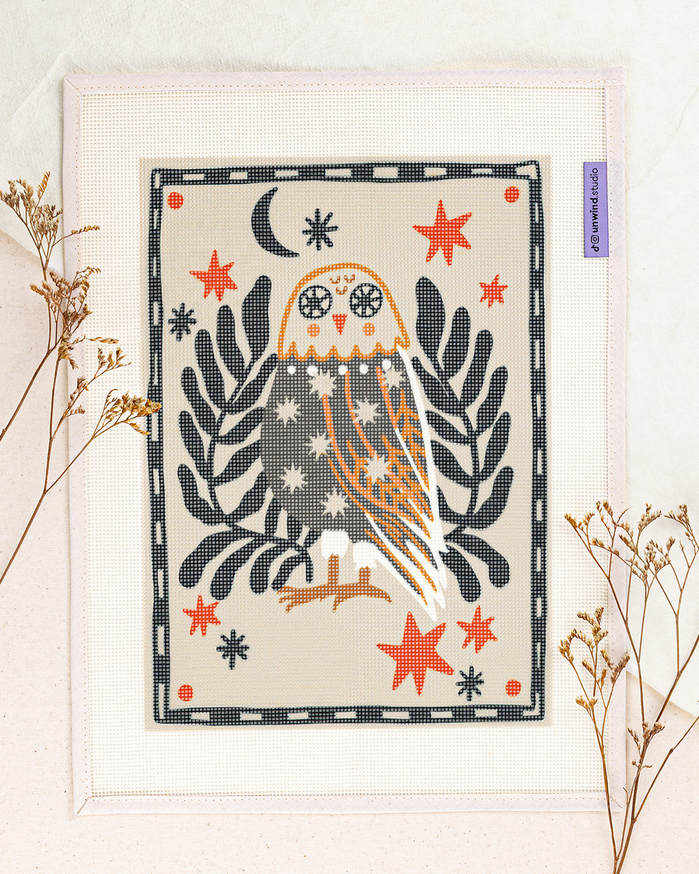 folk owl needlepoint kit by carole hillman: printed canvas of yellow flowers on blue, framed with dried twigs