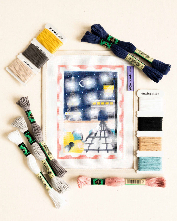 flat lay of the Paris, city of lights needlepoint canvas with matching threads