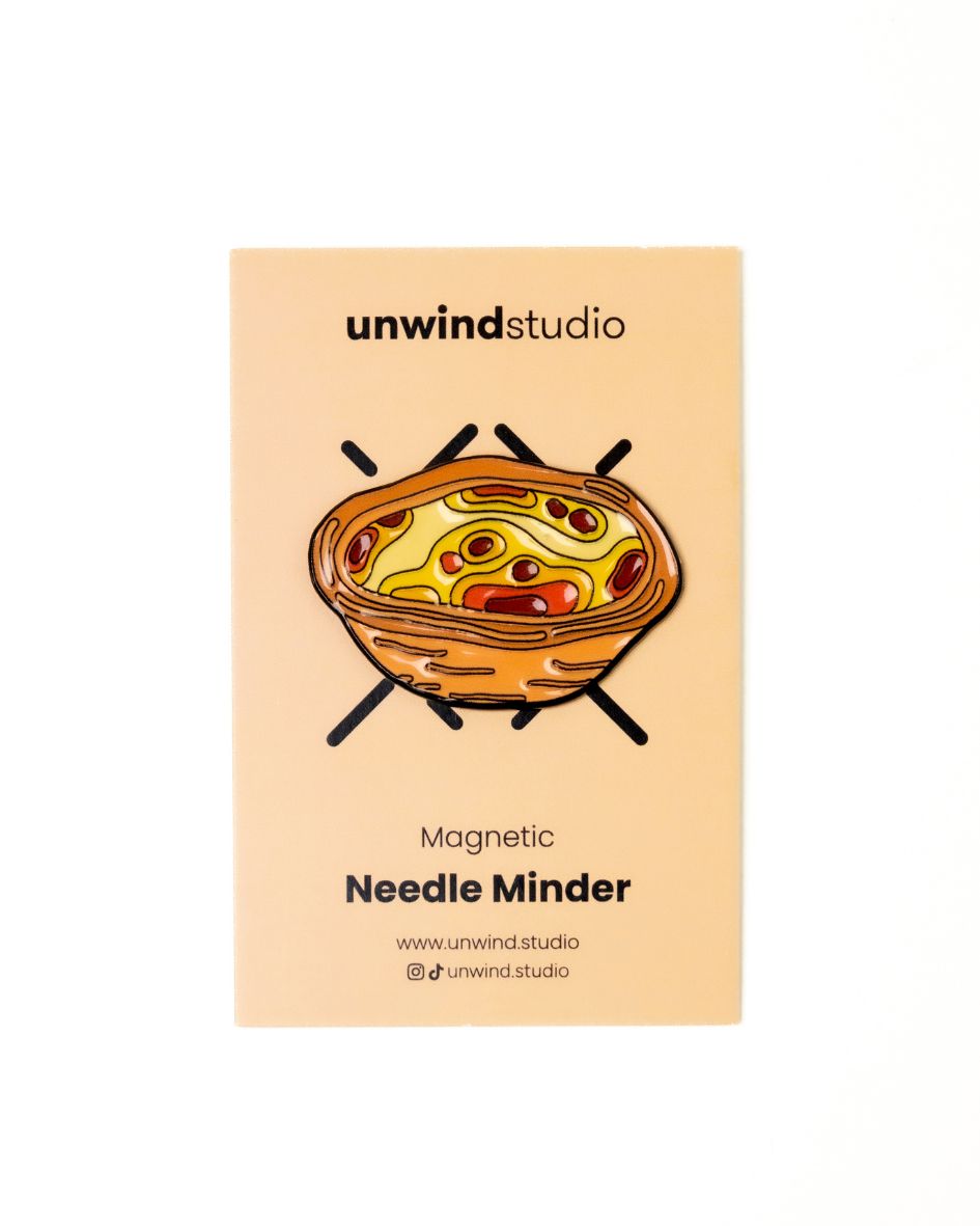 The unwind studio needle minder pastel de nata magnet place on a personalized card.

