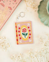 Romance book needlepoint bag charm finished and placed next to matching decor elements