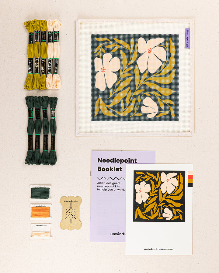 Swaying Blooms needlepoint kit contents: printed canvas, threads, needles, and instruction booklet, graphic flyer laid flat