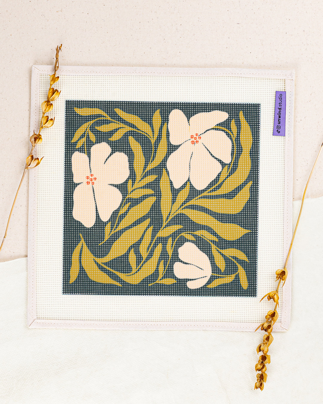 Swaying Blooms needlepoint kit by Ophelia Pang: printed canvas of yellow flowers, framed with dried twigs