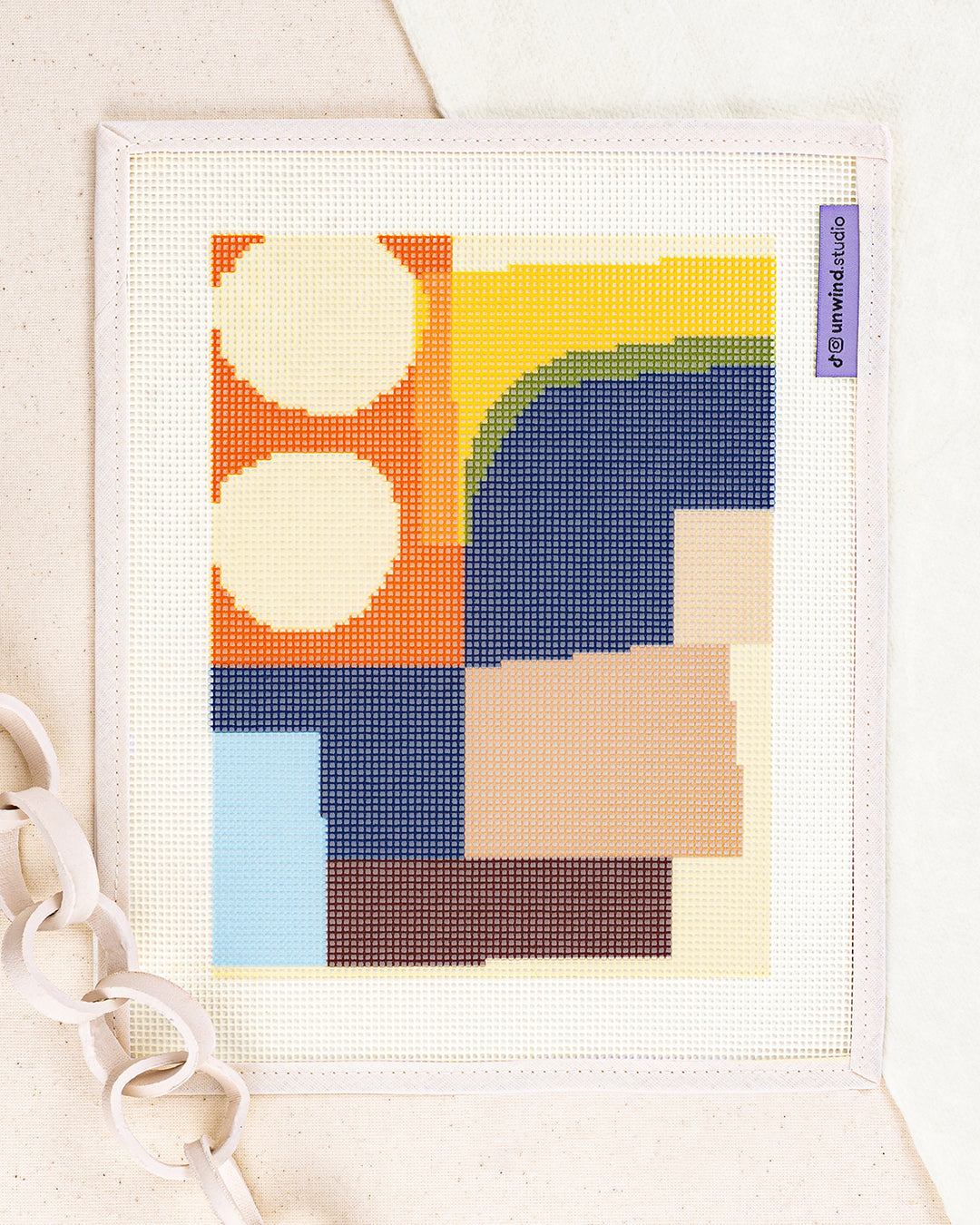theo needlepoint kit by jonathan lawes: printed canvas of yellow flowers on blue, framed with dried twigs