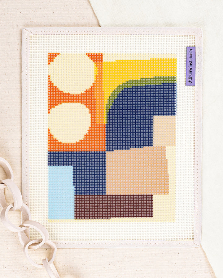 theo needlepoint kit by jonathan lawes: printed canvas of yellow flowers on blue, framed with dried twigs