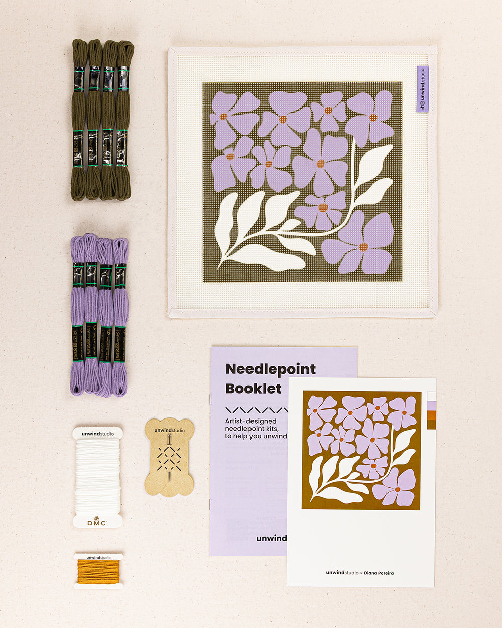 wildflowers needlepoint kit contents: printed canvas, threads, needles, and instruction booklet, graphic flyer laid flat