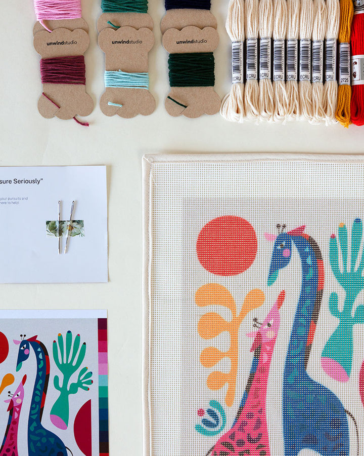 Needlepoint kit with illustration of mom and child giraffes mom and child