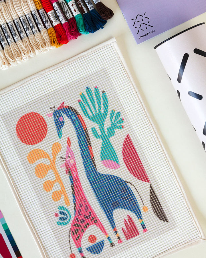 Needlepoint canvas with illustration of mom and child giraffes mom and child