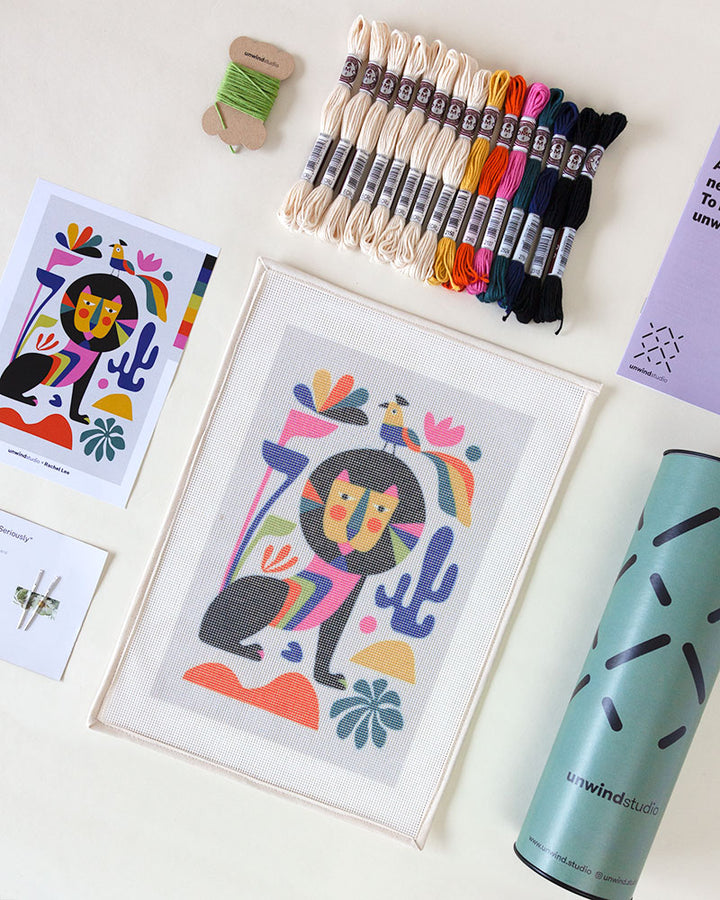 Needlepoint kit with illustration of colorful lion and bird