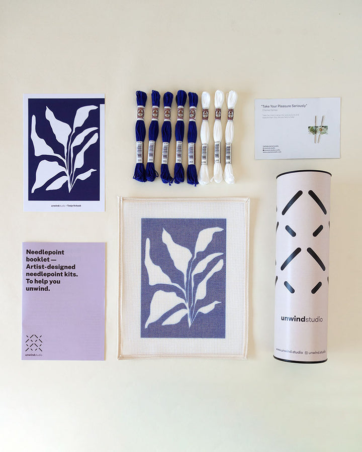 Needlepoint kit with illustration of white plant in blue background