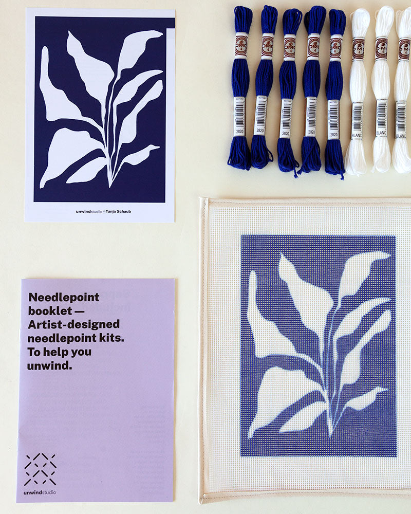 Needlepoint kit with illustration of white plant in blue background