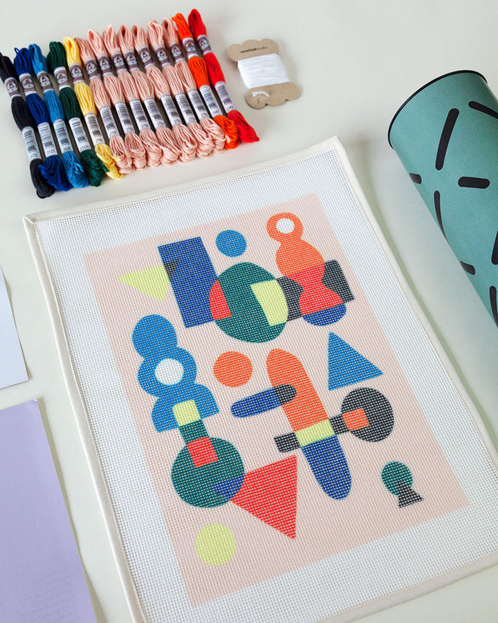 needlepoint kit with abstract illustration, with threads and packaging