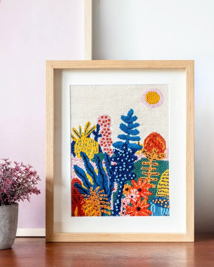 Needlepoint canvas with illustration of garden with colorful plants