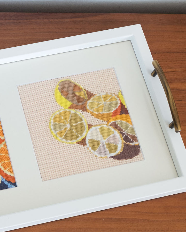tray with framed needlepoint of lemons by Unwind Studio